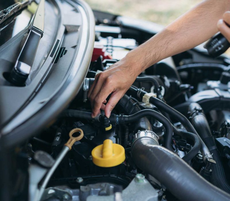 young-man-checking-and-maintenance-on-his-car-car-Q6GA6P2