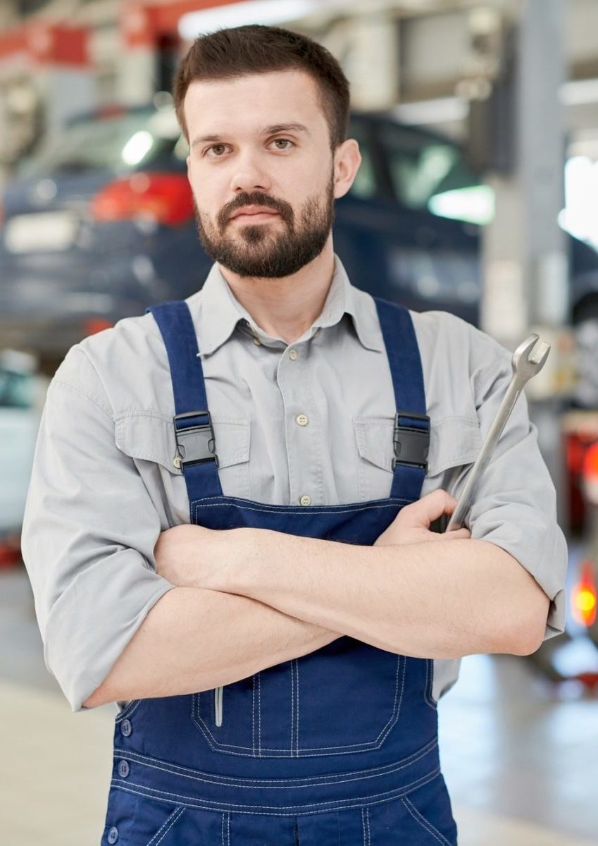 Bearded Mechanic Holding Wrench