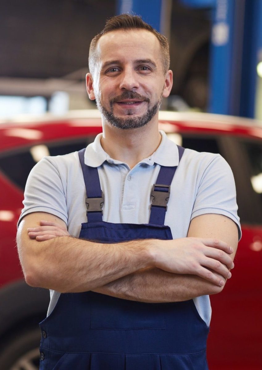 Mechanic Posing with Red Car