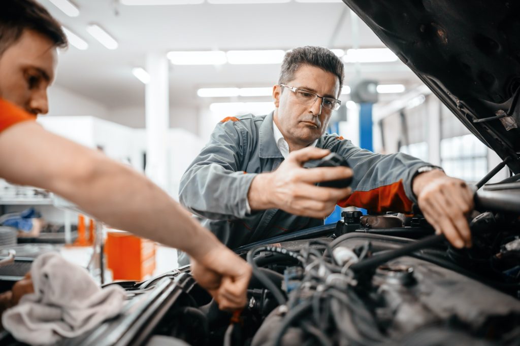 Car mechanics working and maintaining car