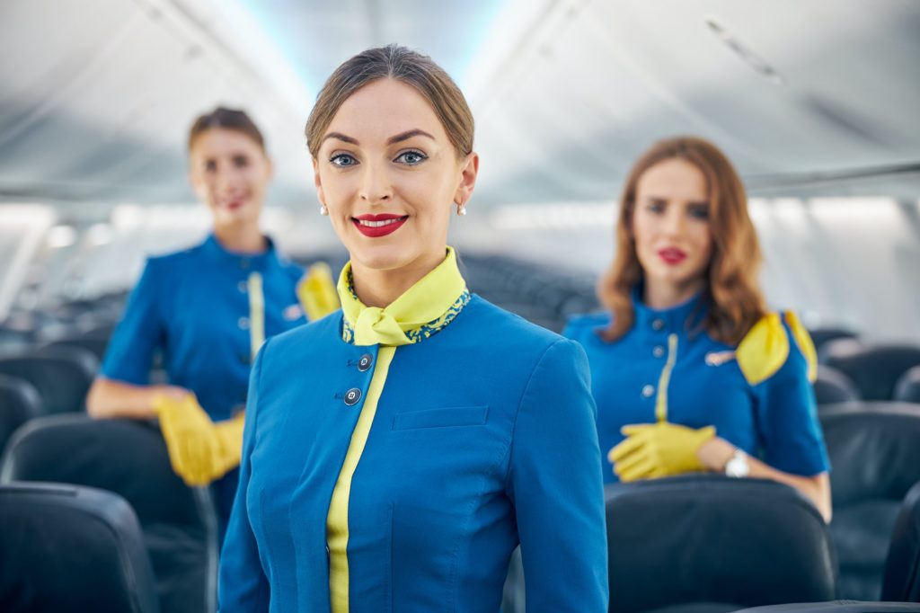 Charming stylish aviation staff of air hostesses