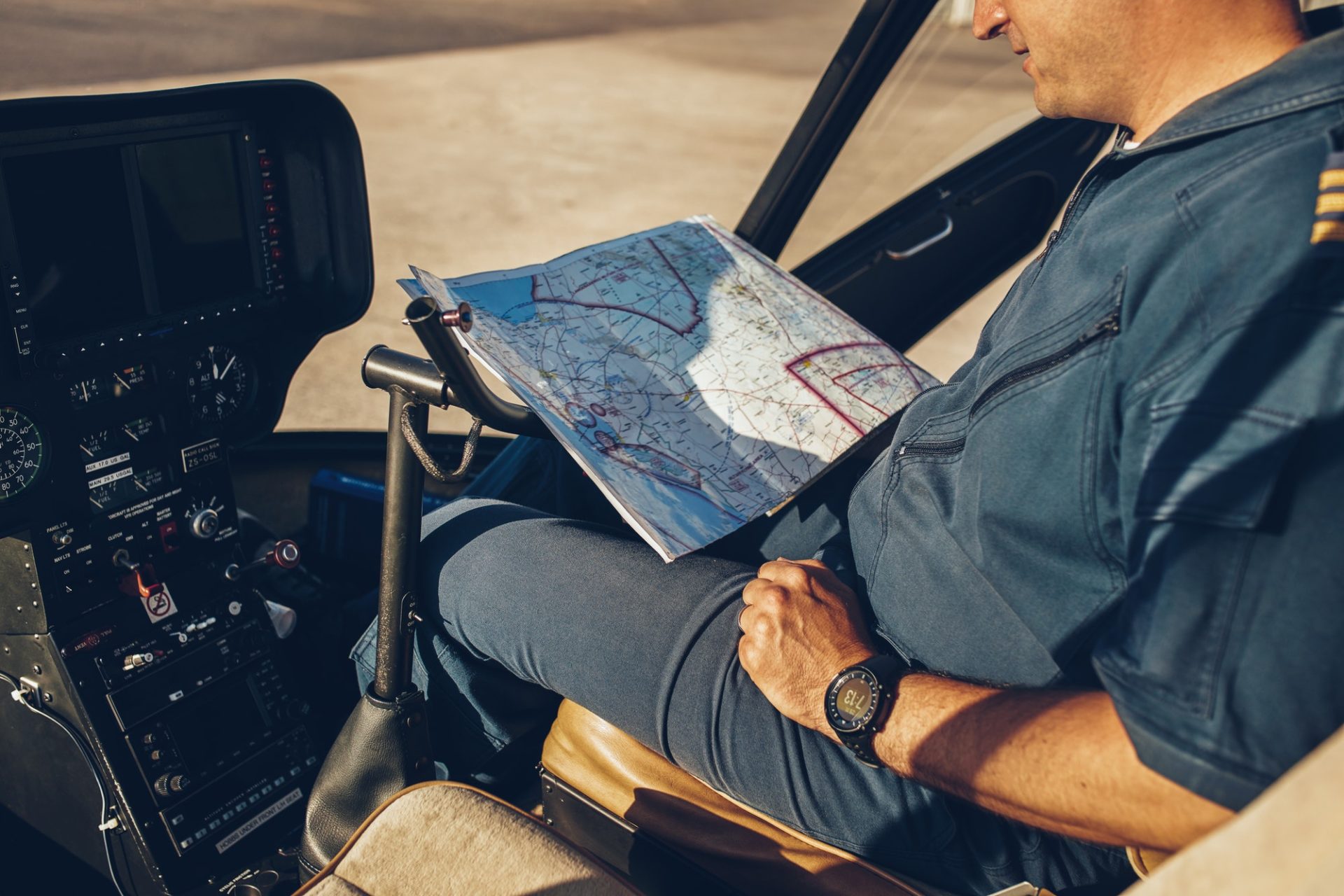 Helicopter pilot reading map.