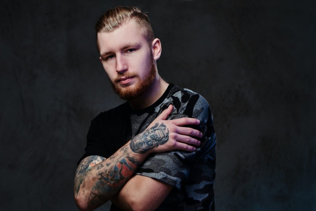 A man with tattoos on arms.