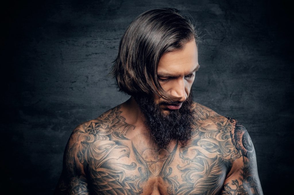 Portrait of a man with tattooed body.