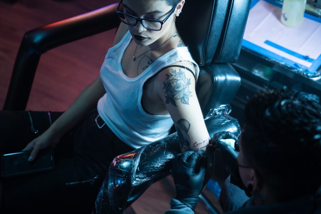 Skilled Man At Work As Professional Artist In Tattoo Studio