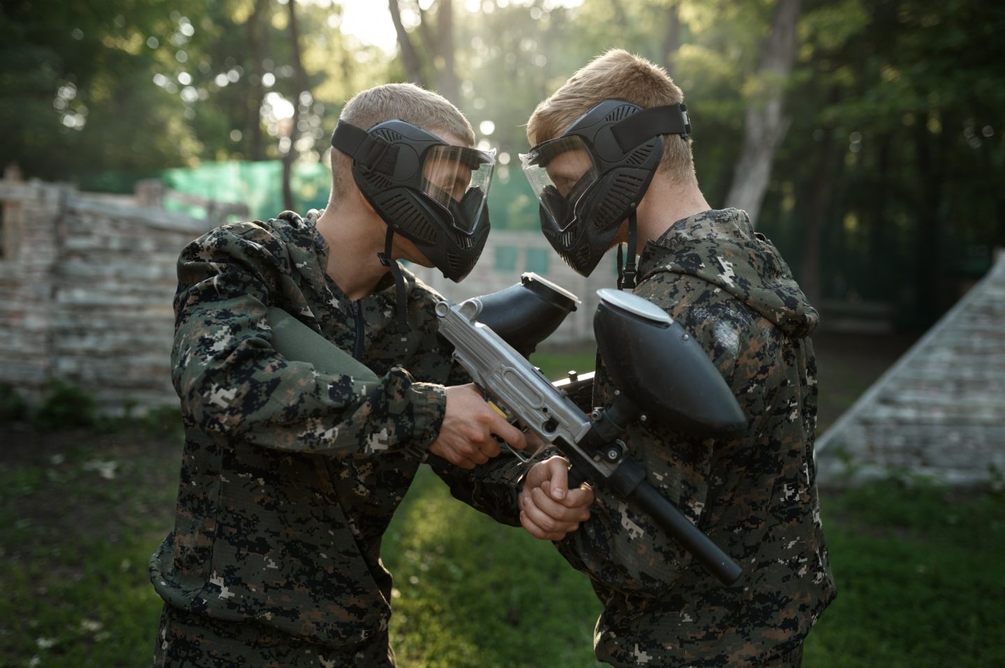 Two paintball players poses on playground