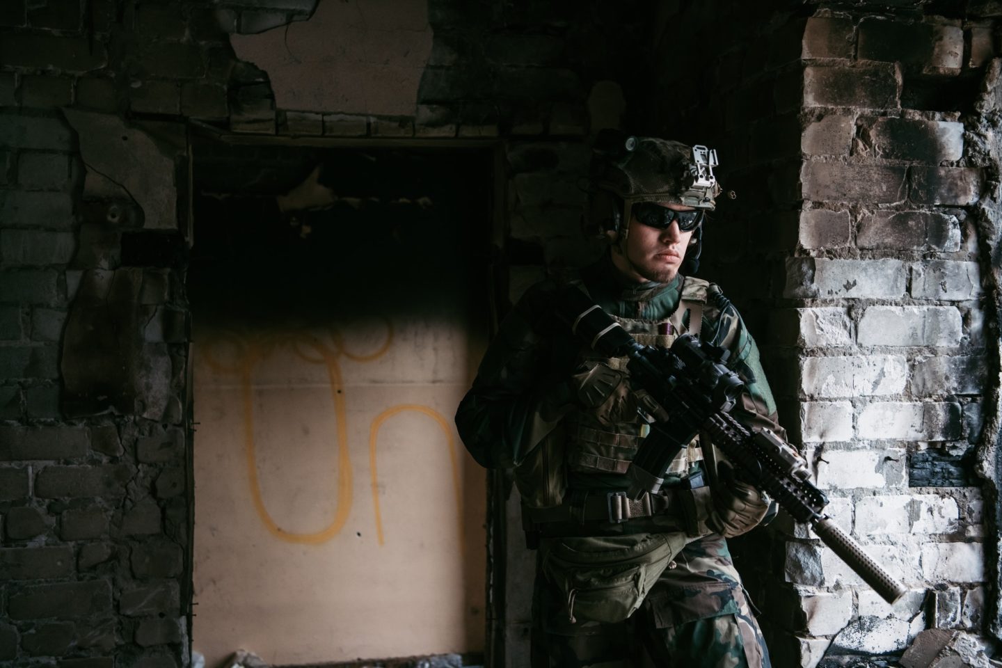 Soldier in combat. Urban combat training, soldier entering abandoned building. Anti terrorist