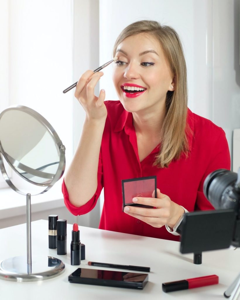 Stylish young woman blogger recording make up video guide on beauty tips