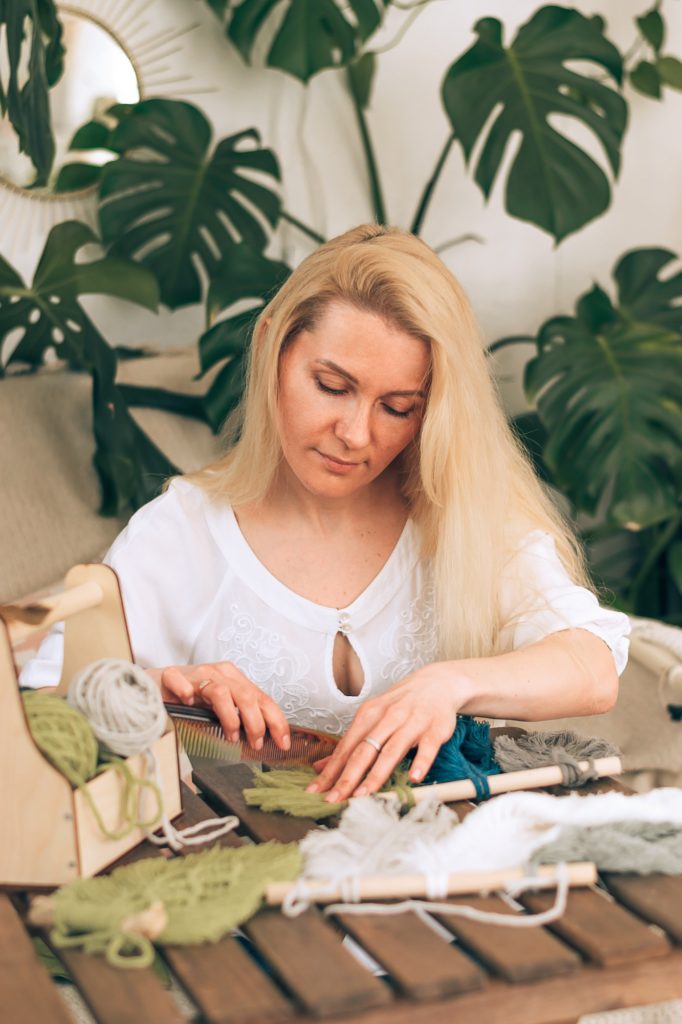 Woman weaving macrame in a home workshop.Handmade concept.