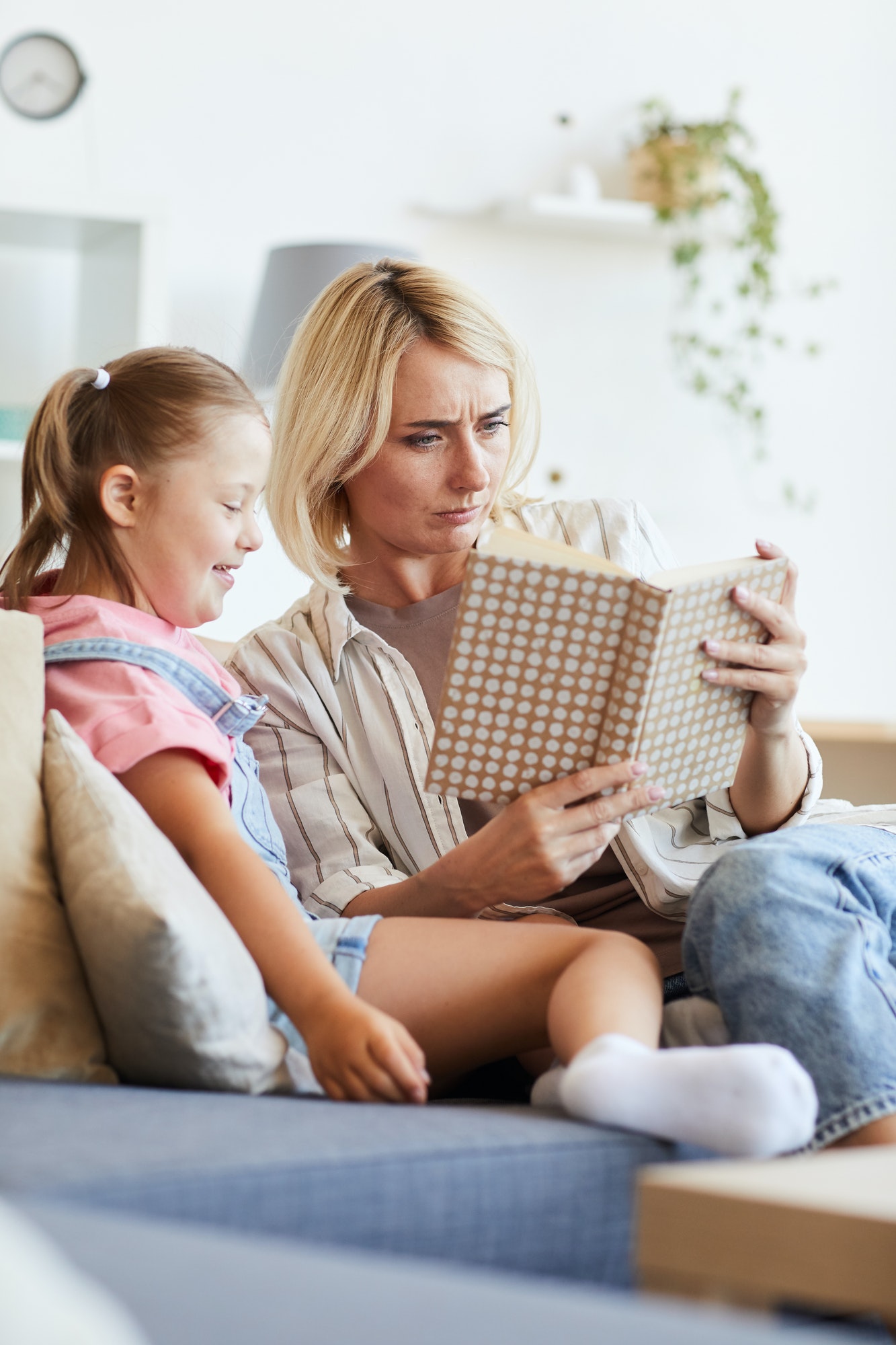 Woman reading a book to girl