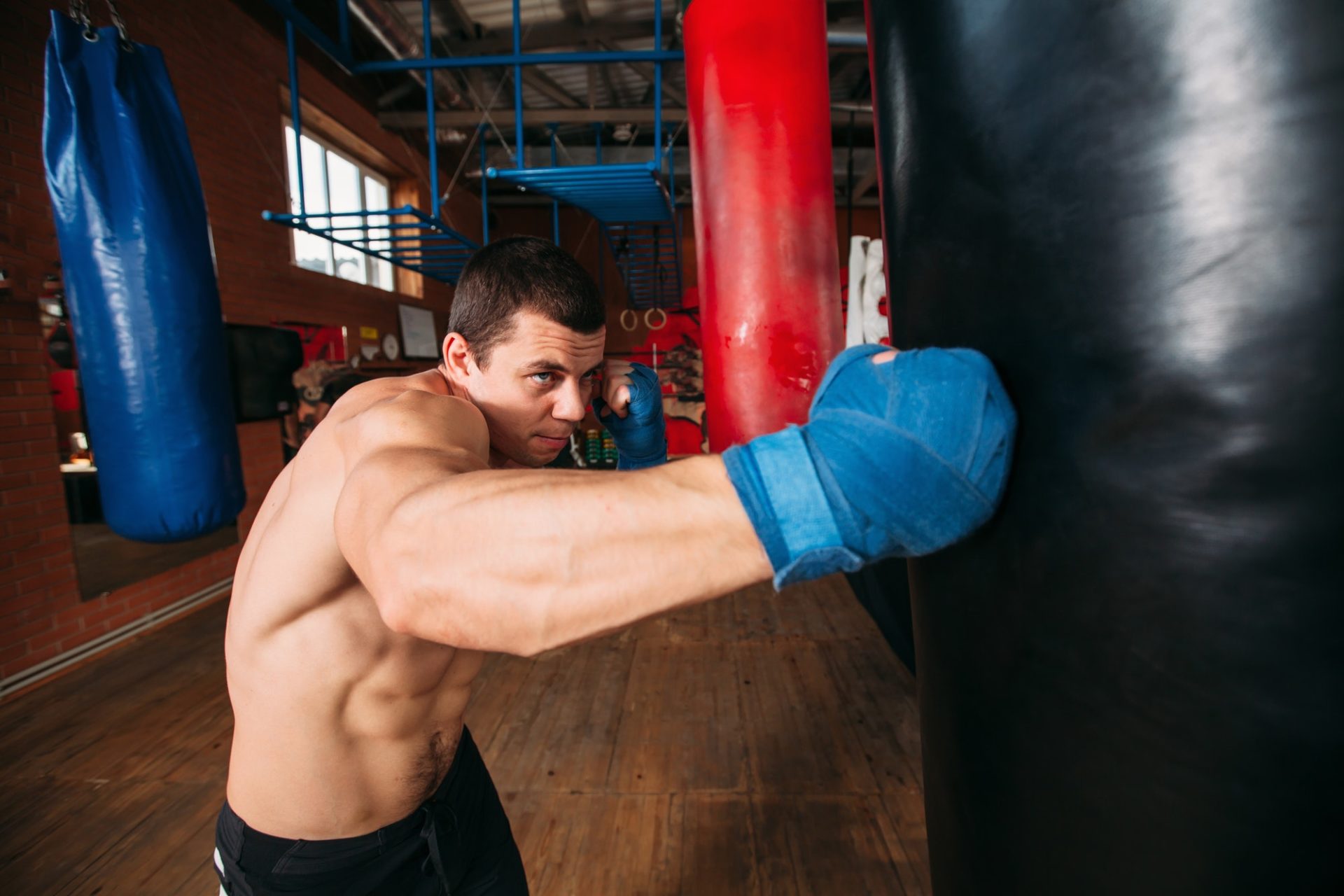 Boxer training with punching bag.