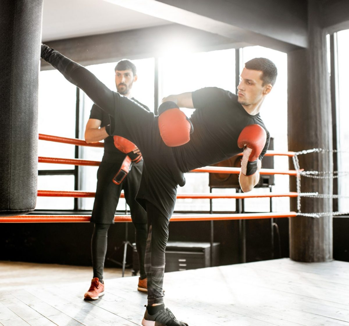 Kickboxer training with punching bag