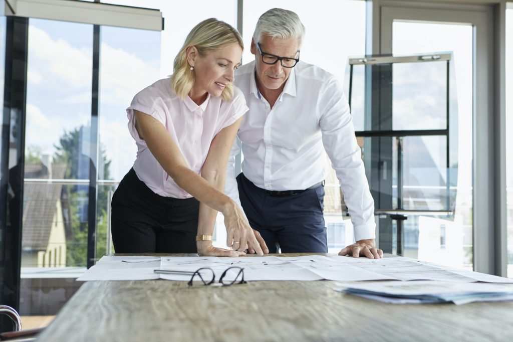 Businessman and woman discussing project in office
