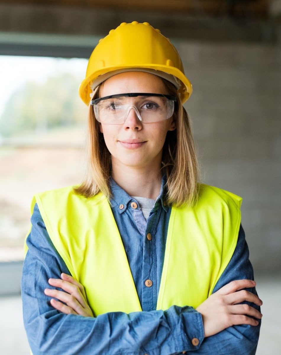 Young woman worker on the construction site.