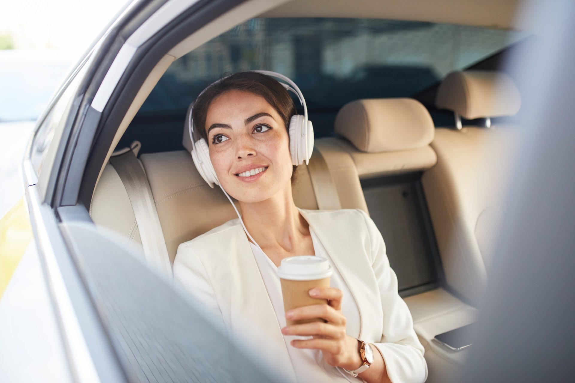 Businesswoman Listening to Music in Taxi
