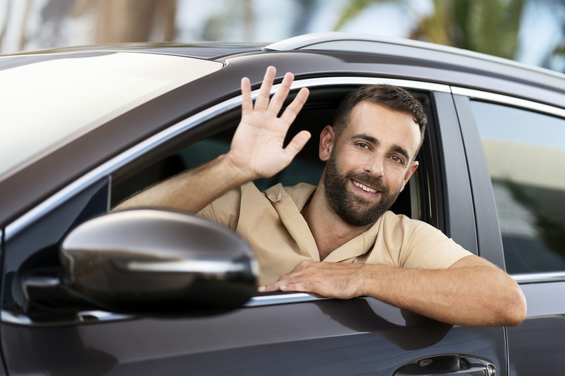 Taxi driver waving hand waiting for client sitting in car. Transportation concept