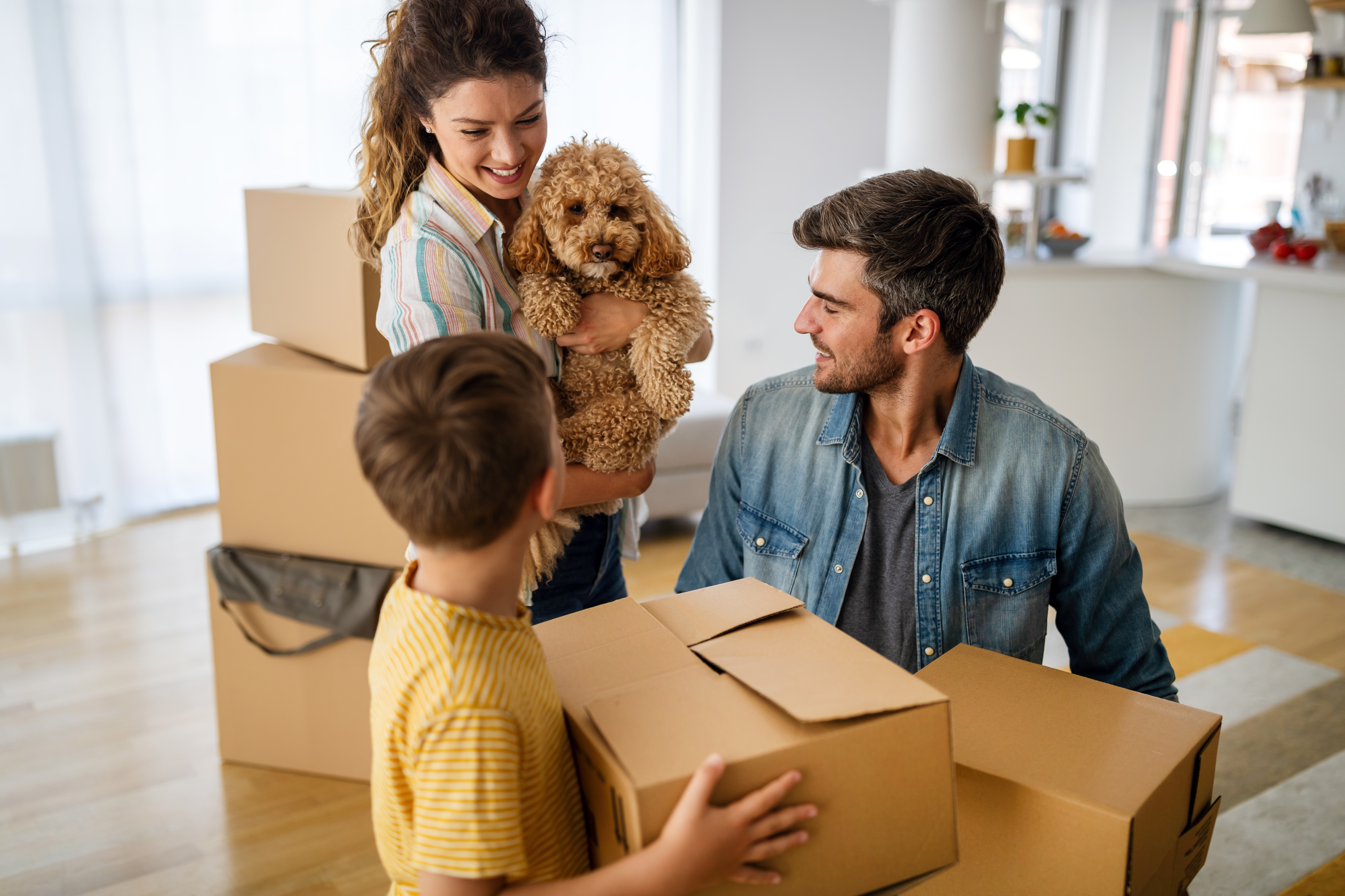 Husband and wife and their son with pet moving in new home