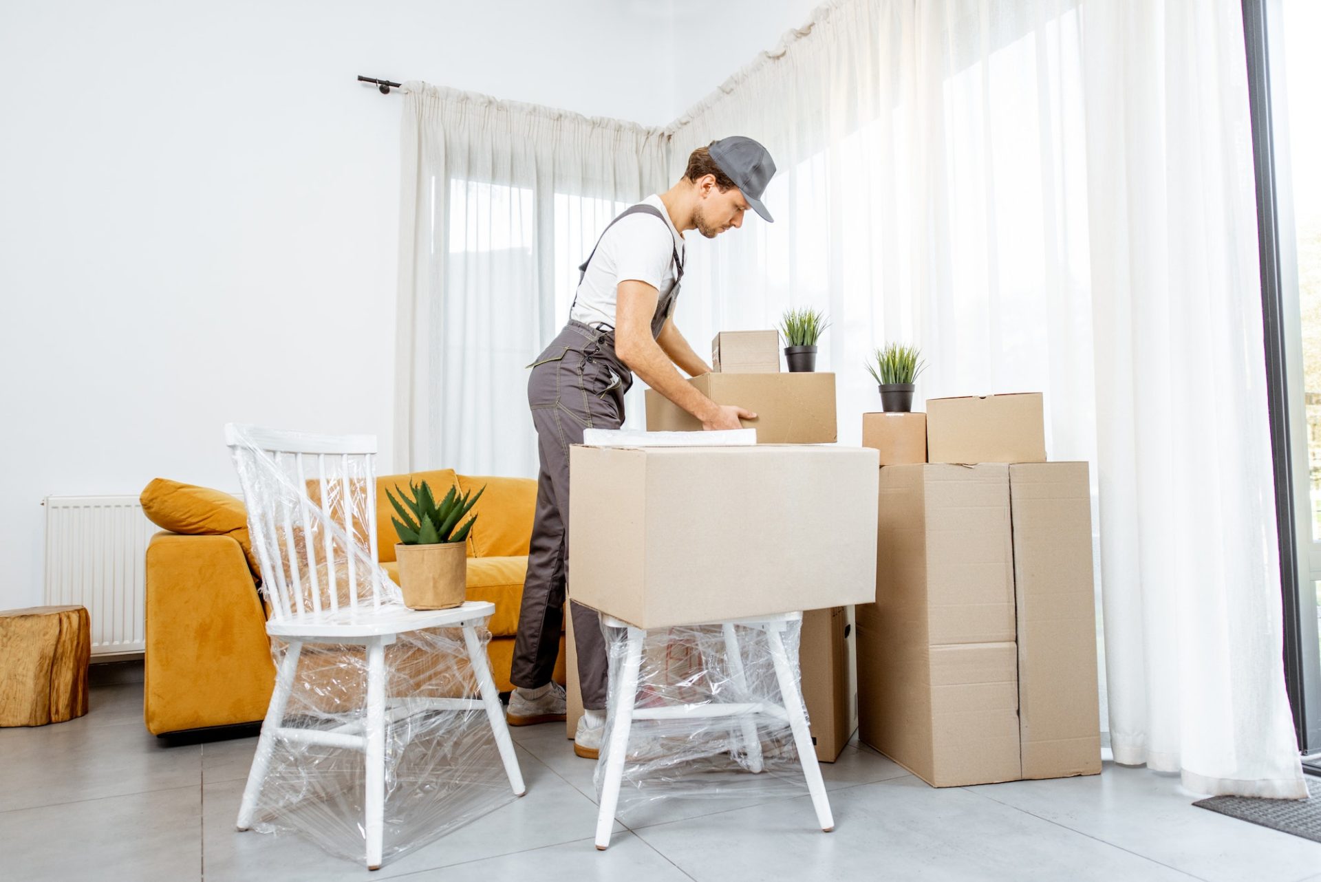 Professional mover delivering furniture to a new house