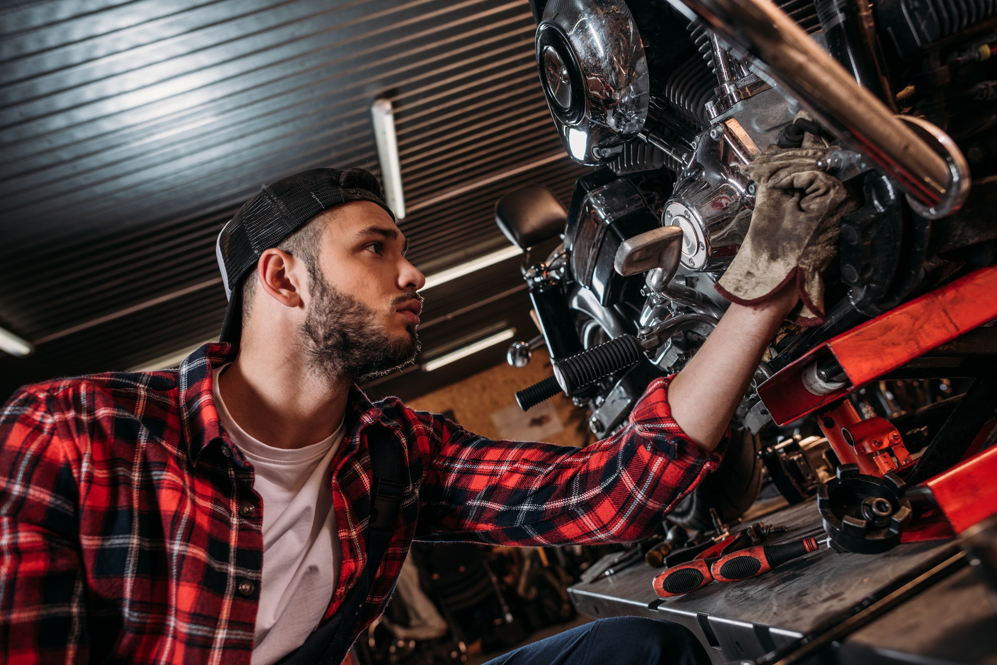 handsome bike repair station worker fixing motorcycle
