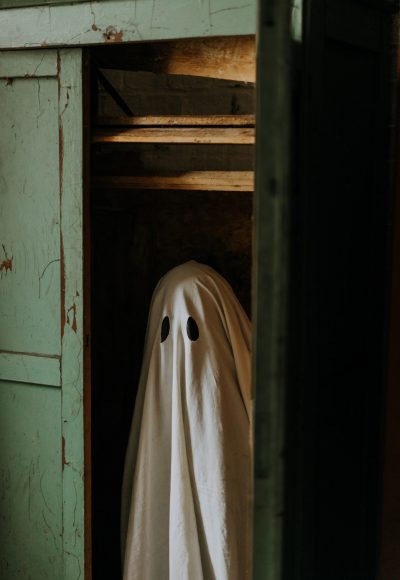 little ghost standing in the closet. Autumn halloween