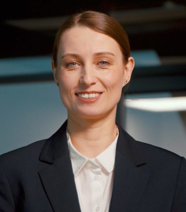 Young businesswoman smiling and looking at camera.