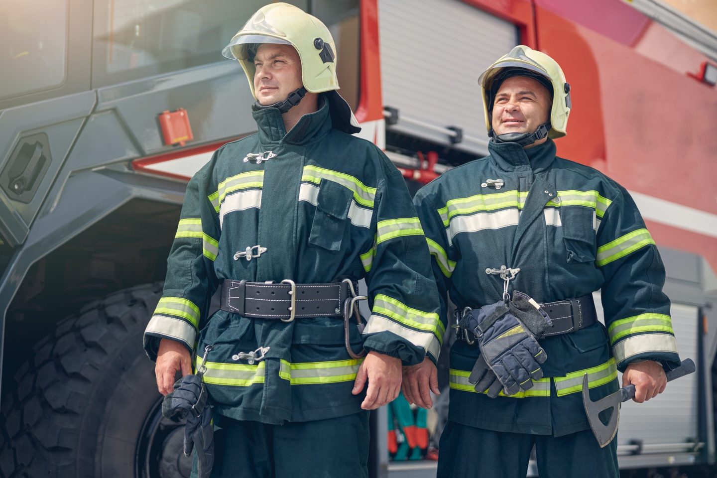 Males wearing protective fire uniform with helmets on head