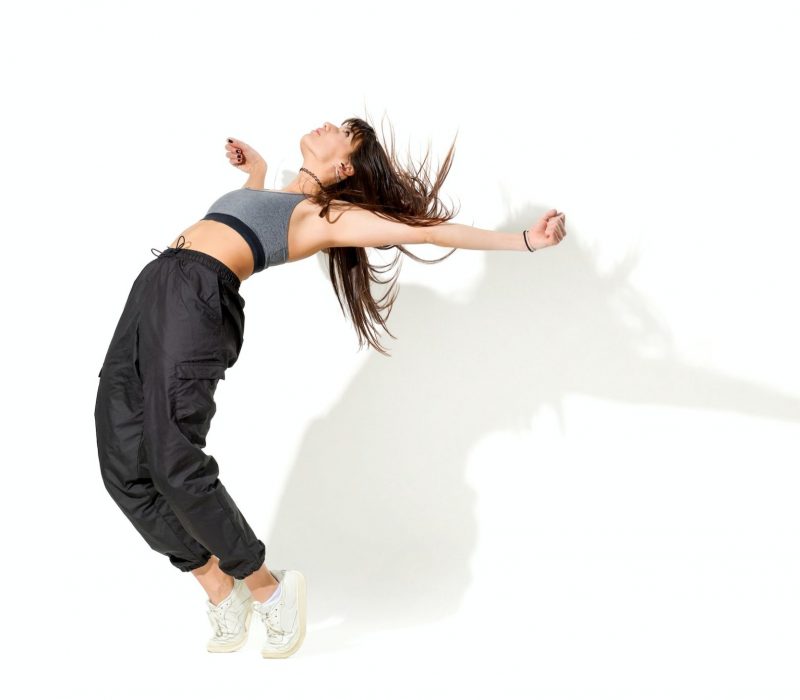 Flexible woman dancing hip hop in studio