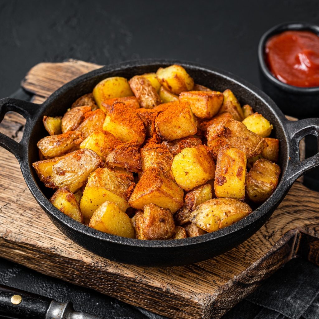 Patatas bravas, spicy potatoes, a Spanish dish with fried potato and a spicy garlic sauce.