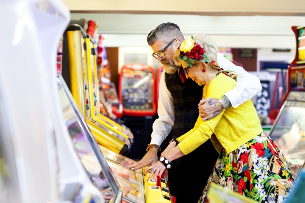 Couple enjoying themselves in amusement arcade, Bournemouth, England