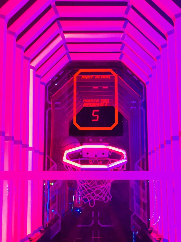 Playing a digital game of basketball at the arcade