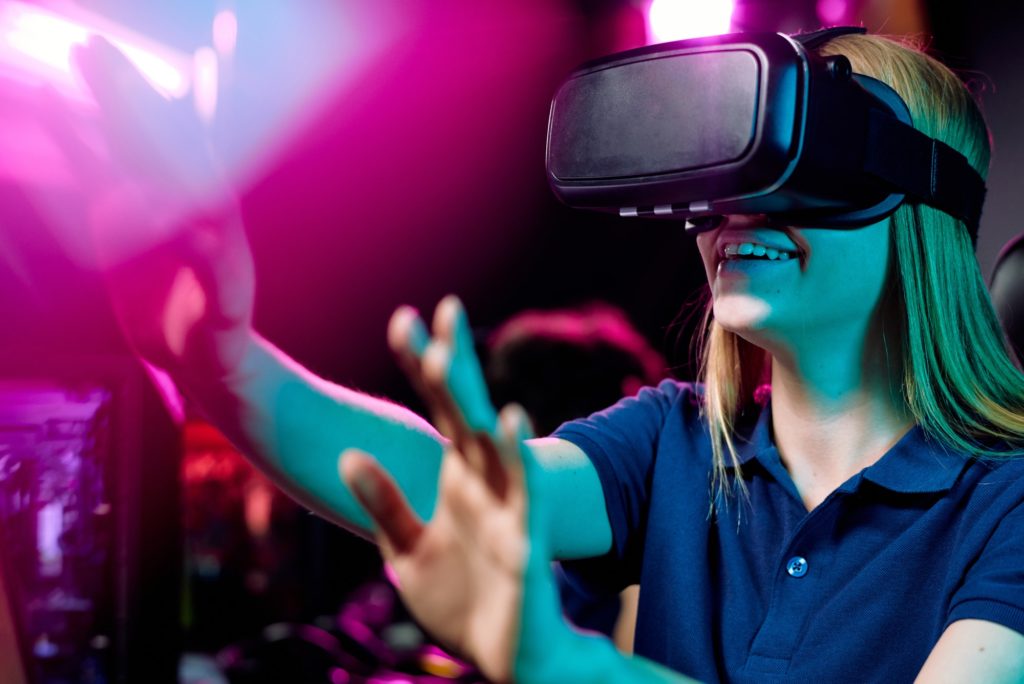 Positive girl enjoying video game in 3D goggles