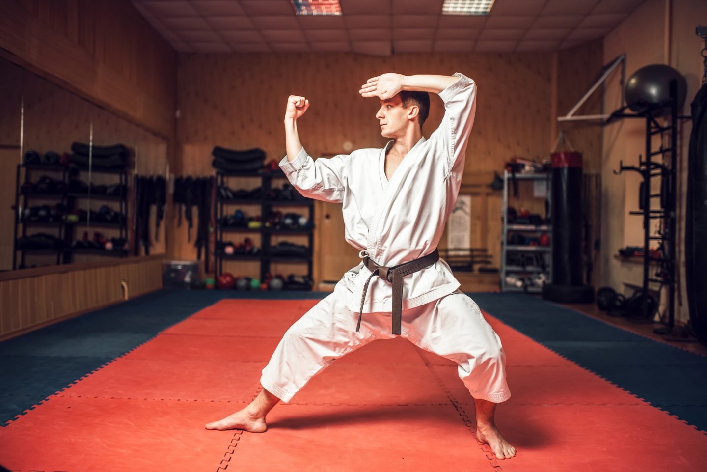 Martial arts master on fight training in gym