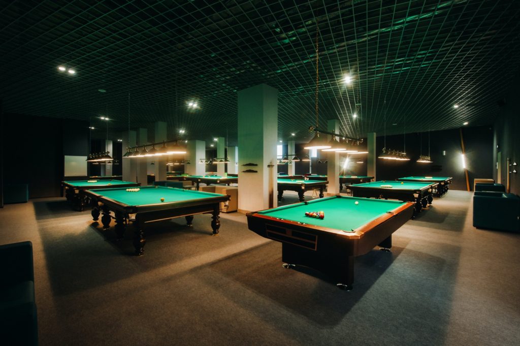 Billiard table with green surface and balls in the billiard club.Pool Game