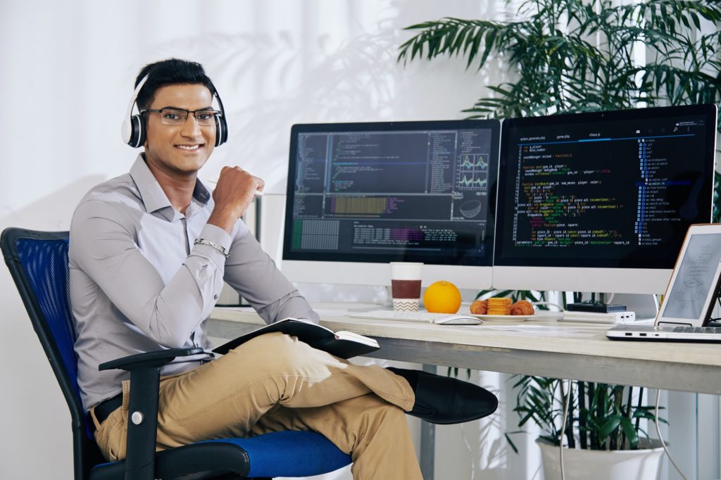 Smiling confident Indian coder
