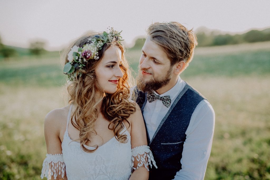 Beautiful bride and groom at sunset in green nature.