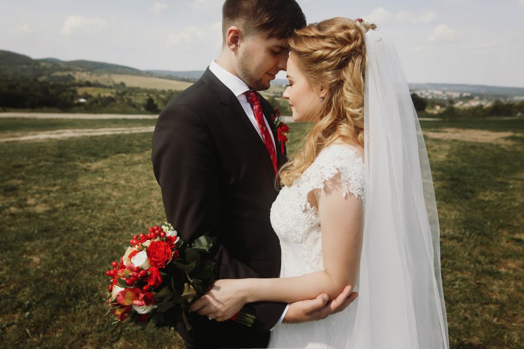 gorgeous bride and groom posing at field