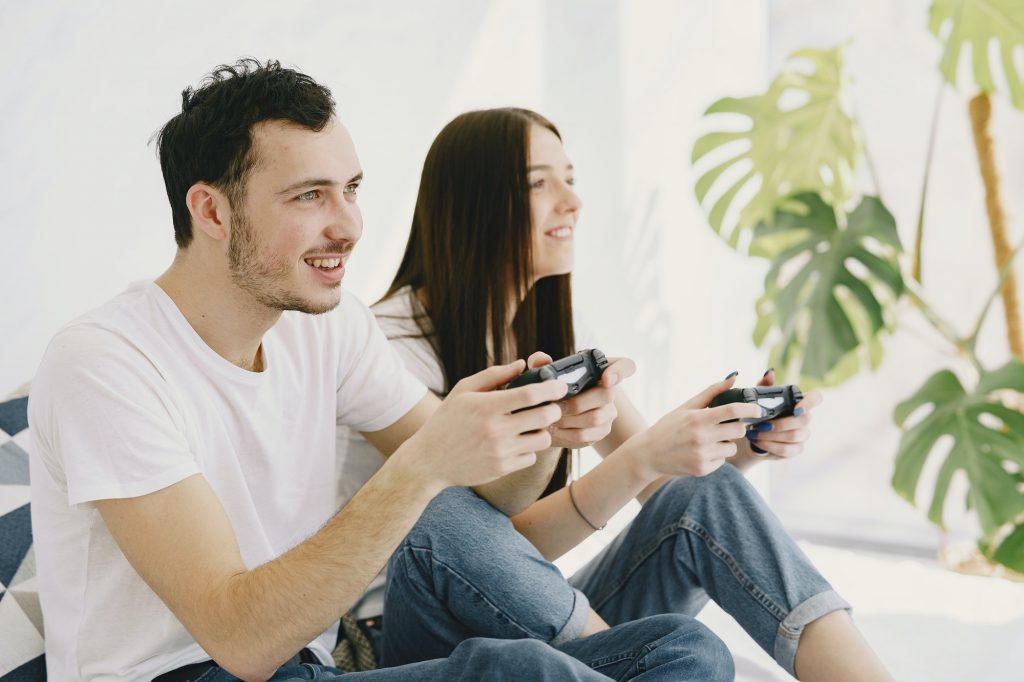 Couple at home playing in a video games