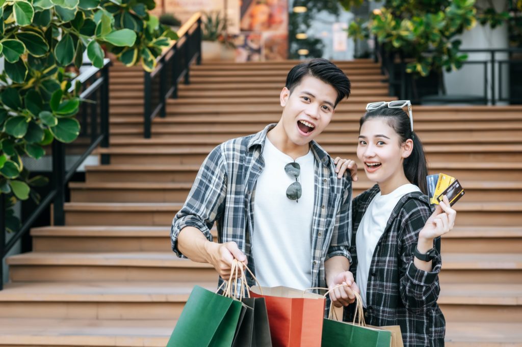 Happy couple shopping and payment by credit card