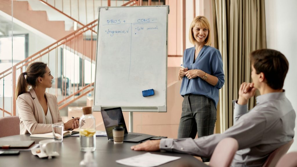 Happy businesswoman talking to her colleagues during a presentation in the office