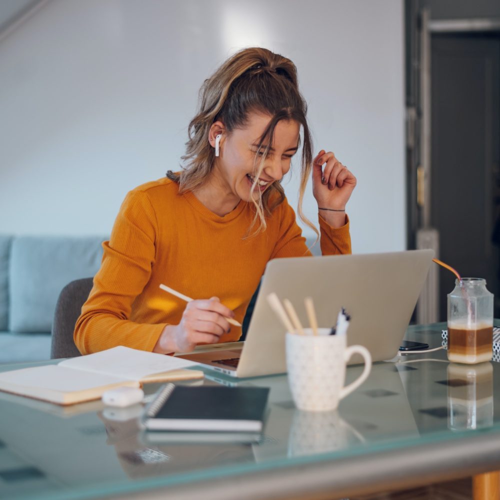 Woman having web call on a laptop while working at home