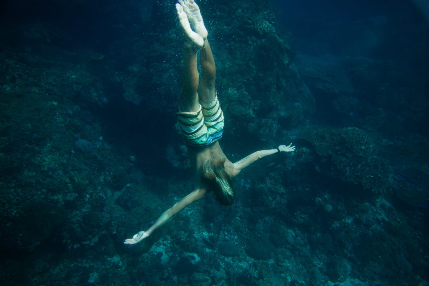 partial view of man diving in ocean alone