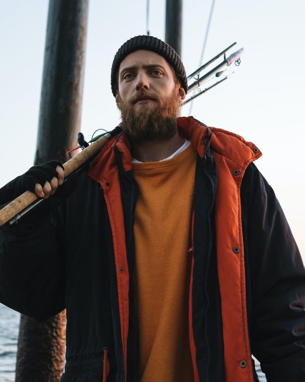 Handsome brutal bearded fisherman wearing coat