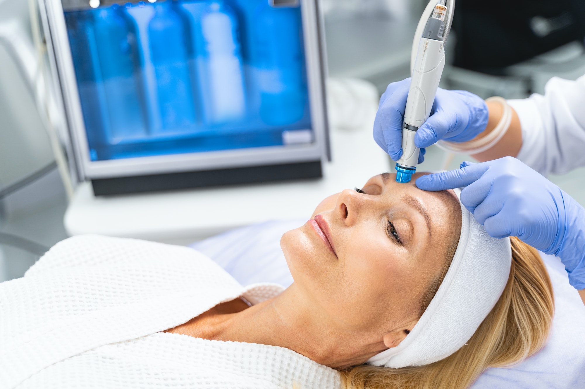 Female patient undergoing a facial hydrodermabrasion treatment