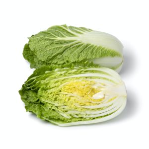 Whole and half fresh raw Chinese cabbage on white background