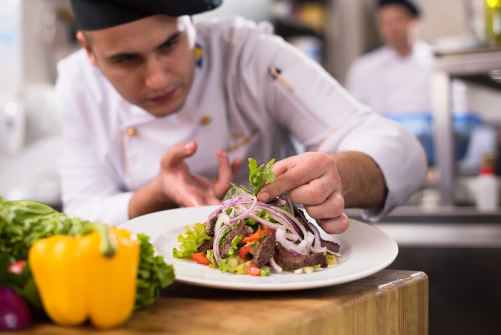 cook chef decorating garnishing prepared meal