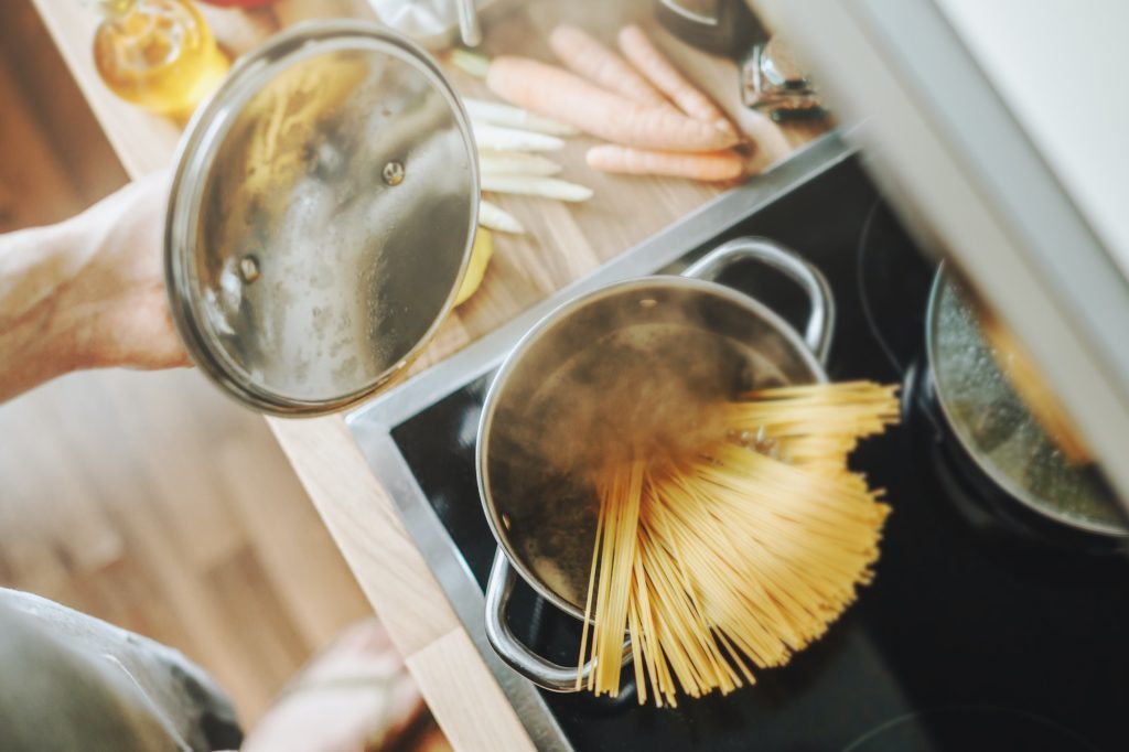 Man cooking pasta in the kitchen