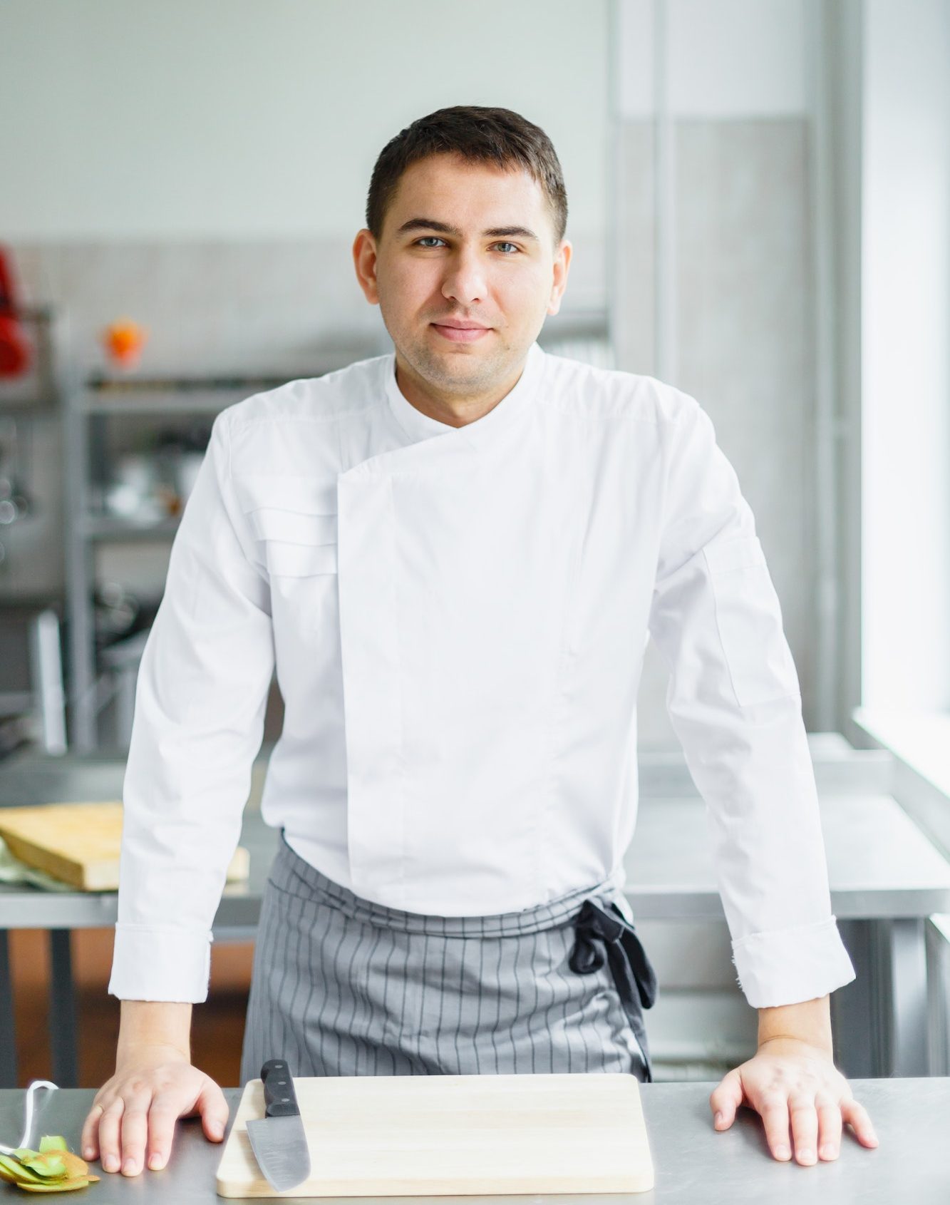 Young smiling male chef posing