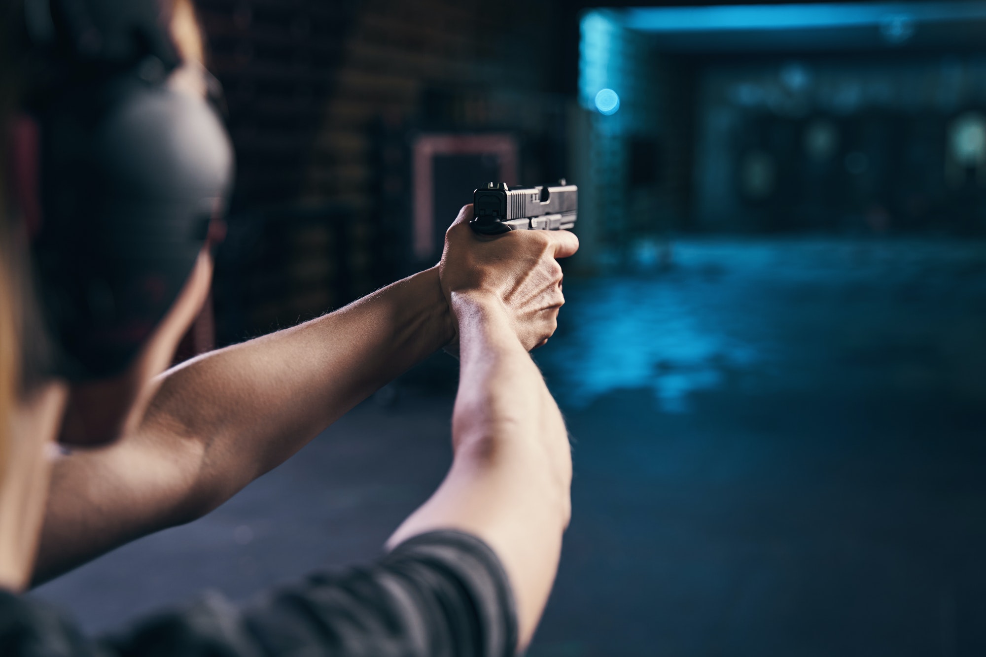 Shooter practicing a two-handed hold at a shooting range