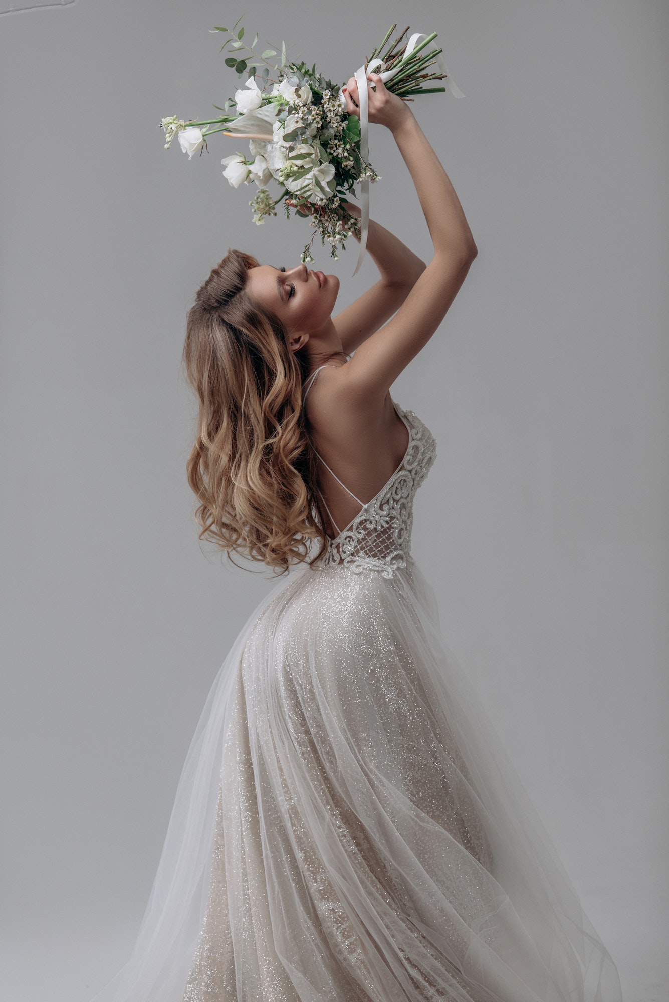 beautiful sexy blonde bride. posing in wedding dress in white room