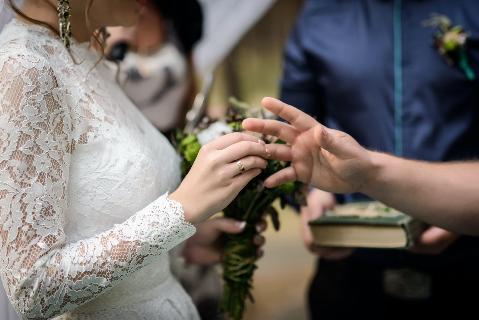 bride puts wedding ring